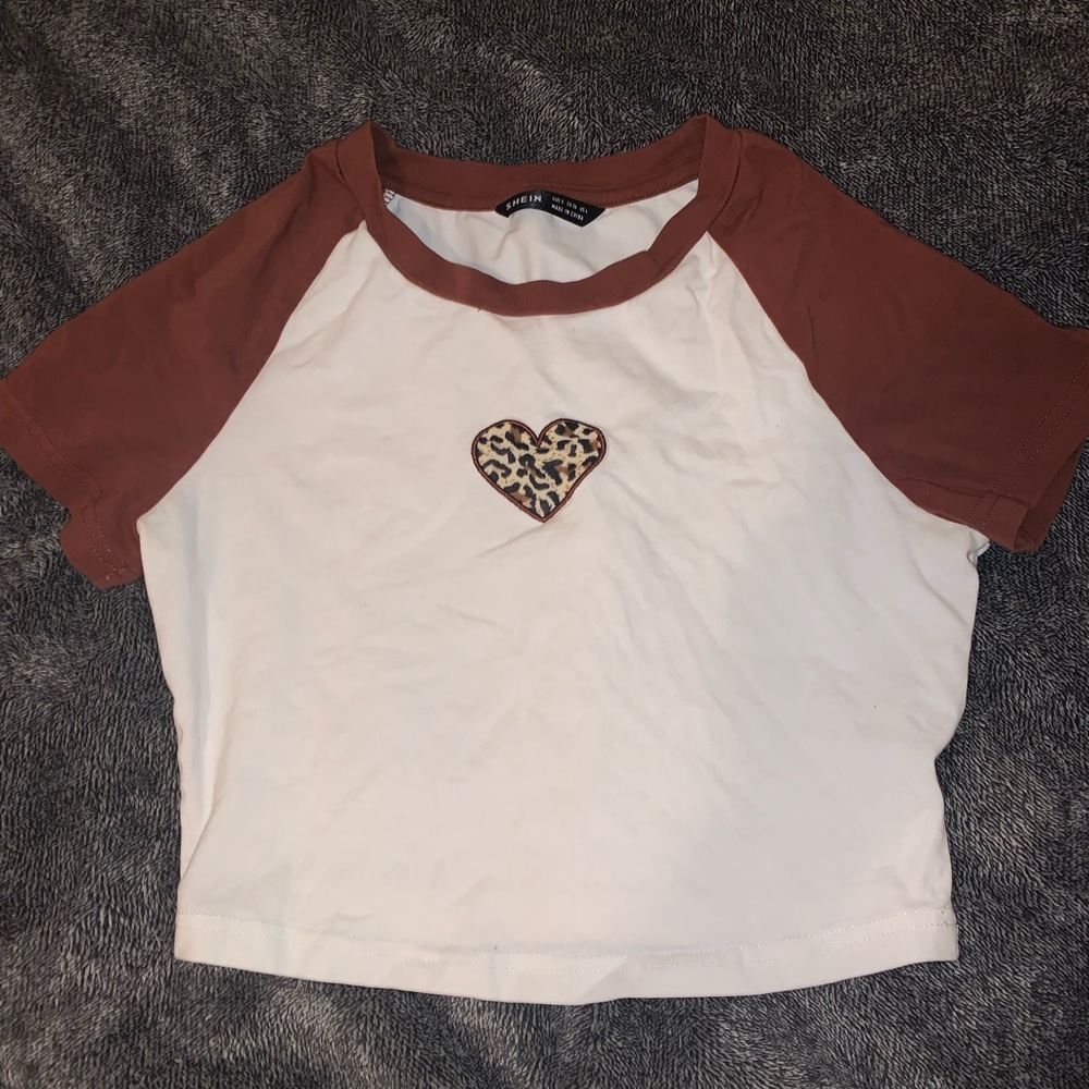 Cropped white shirt with brown sleeve. And cheetah print heart.